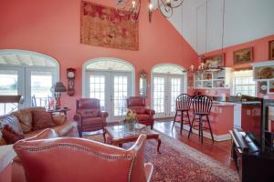 a living room with a couch and a table at Exquisite Lake Charles Gem - Waterfront Views in Lake Charles