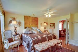 a bedroom with a bed and a ceiling fan at Exquisite Lake Charles Gem - Waterfront Views in Lake Charles