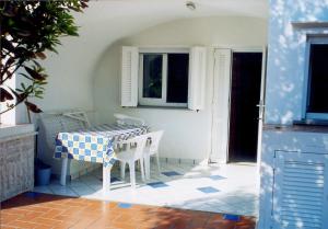 a table with a blue and white table cloth on it at L'Isolana Case Vacanza Alloro 2 in Ponza