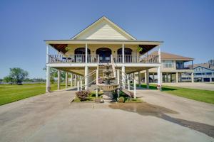 a large white house with a porch and a fountain at Exquisite Lake Charles Gem - Waterfront Views in Lake Charles