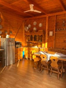 a kitchen with a table and a refrigerator at Villa Rosa in Canicattini Bagni