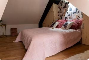 a bedroom with a large bed with a wooden headboard at Maison de village in Chirac