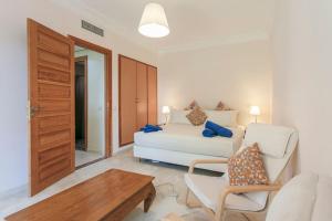 a living room with a white couch and a table at Solarium Retreat - Marrakech in Dar Caïd Layadi