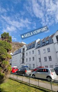 a building with cars parked in a parking lot at Central Apartment Ålesund in Ålesund