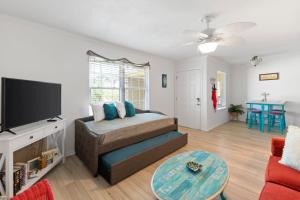 a living room with a couch and a flat screen tv at Schooner by the Sea -- Beach and History await in Saint Augustine Beach