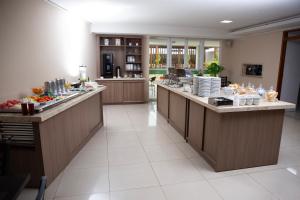 a buffet line in a restaurant with food at Oasis Hotel in Cajazeiras