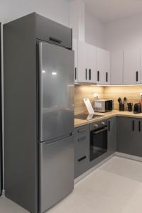 a kitchen with a large stainless steel refrigerator at Harmony Luxury 1 in Ierápetra