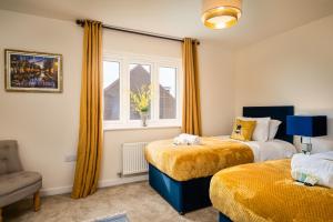 a bedroom with two beds and a window at Poppy House - Coastal Getaway 2 Bedroom in Scalby in Scalby