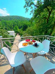 a table and chairs with a plate of food on it at Green Garden Dilijan in Dilijan