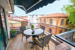 a balcony with a table and chairs on a balcony at Loren Hotel&Suites in Istanbul