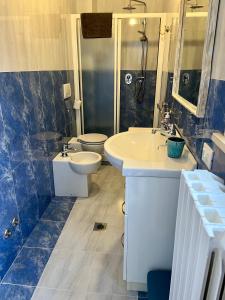 a bathroom with two sinks and a toilet and a shower at mineVaganti in Ancona +26 photos