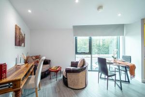 a living room with a dining room table and chairs at Corner studio apartment in Sheffield in Sheffield