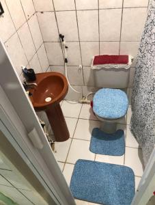 a small bathroom with a toilet and a sink at Traveler gu's room AP compartilhado in Fortaleza