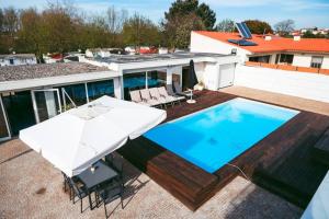 an overhead view of a swimming pool and an umbrella at Marlages House in Lavra