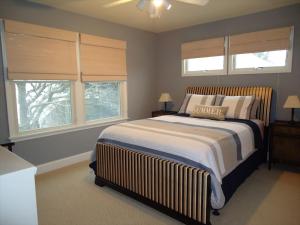 a bedroom with a large bed and two windows at Peachbrook, Llc in Brant Beach