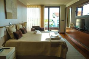 a bedroom with a large bed and a television at Marlages House in Lavra