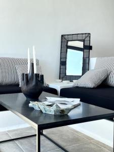 a black coffee table in a living room with a couch at Amenti Horizon View in Agkidia