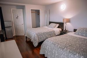 a hotel room with two beds and a door at HOV B&B House -Hospitality Ocean View Victoria- in Victoria