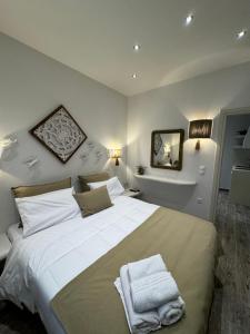 a bedroom with a large bed with two towels on it at Naxos Petite Studios in Agios Prokopios