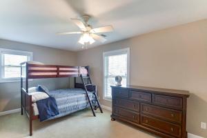 a bedroom with a bunk bed and a ceiling fan at Rock Island Home with Private Yard and Fire Pit Table! in Rock Island
