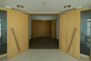 an empty hallway with wooden doors in a building at Château Bernhart 