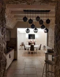 a kitchen and dining room with a table and chairs at Villa Brachychiton in Ostuni