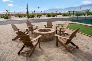 a group of chairs sitting around a fire pit at RV41-LOT ONLY- Paradise RV park in Desert Hot Springs