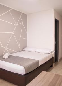 Voodi või voodid majutusasutuse HOTEl INTER DEL CAFE toas