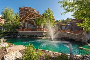 a fountain in a pool in front of a house at Westgate 2BR, private balcony, multiple pools, resort amenities, tennis, onsite spa, restaurant 3912 in Park City
