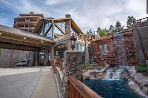an exterior view of a house with a waterfall at Westgate 2BR, private balcony, multiple pools, resort amenities, tennis, onsite spa, restaurant 3912 in Park City