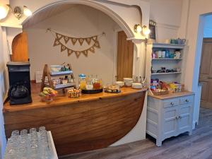a kitchen with a wooden counter with a boat in it at Harbourlight Guesthouse in Saundersfoot