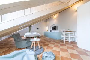 a room with an attic with a table and chairs at Kenova Apartments Old Town in Dubrovnik