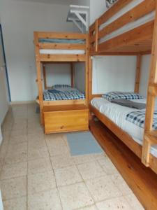 two bunk beds in a room with wood at Agua de Sonho 2 in Bensafrim