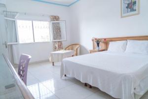 Postel nebo postele na pokoji v ubytování Hotel Azur Conakry
