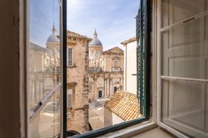 an open window with a view of a building at Kenova Apartments Old Town in Dubrovnik
