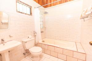 a bathroom with a toilet and a tub and a sink at Jaguarundi Jungle Lodge - Monteverde in Monteverde Costa Rica +52 photos