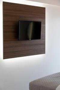 a flat screen tv hanging on a wall at MY PHOS Boutique Apartments in Nikiana