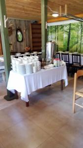 a table with plates and cups on top of it at Dom Glówny 