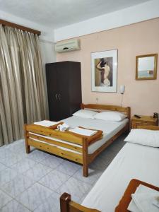 a hotel room with two beds in a room at AlenStudios in Paralia Katerinis +86 photos