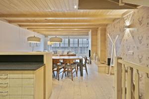 a kitchen and dining room with a table and chairs at Luderna - Casa Val de Ruda IV des Artiguetes in Baqueira-Beret +21 photos