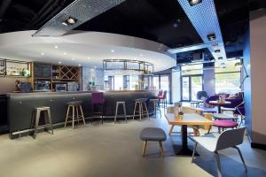 un bar dans un restaurant avec des tables et des chaises dans l'établissement Campanile Lyon Centre - Gare Perrache - Confluence, à Lyon