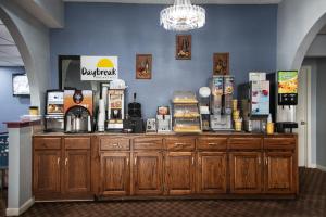 a counter in a restaurant with a coffee shop at Days Inn by Wyndham Troy in Troy