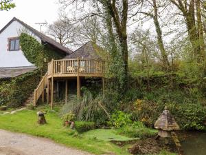 a house with a deck on the side of a hill at The Roundhouse in Okehampton