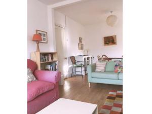 a living room with two couches and a table at Morwelir Llangrannog in Llangrannog