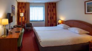 Postel nebo postele na pokoji v ubytování Parkhotel Valkenburg
