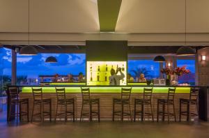 a bar in a restaurant with stools at Annabelle Beach Resort in Hersonissos