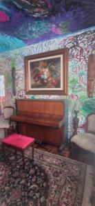 a room with a piano and a painting on the wall at Multitudenow in Florianópolis