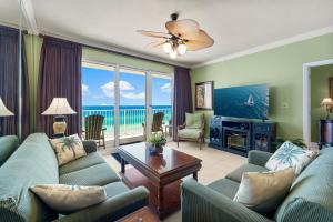 a living room with a couch and a table at Beachfront Bliss Luxe 3BR Condo at Marisol Complex in Panama City Beach