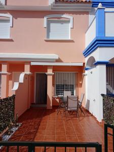 a patio of a house with chairs and a table at Casa Calypso San Juan de los Terreros in San Juan de los Terreros
