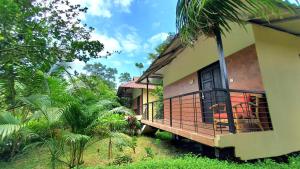 a house with a balcony with a dog in it at Kokomo Sunset Resort in Gazipur